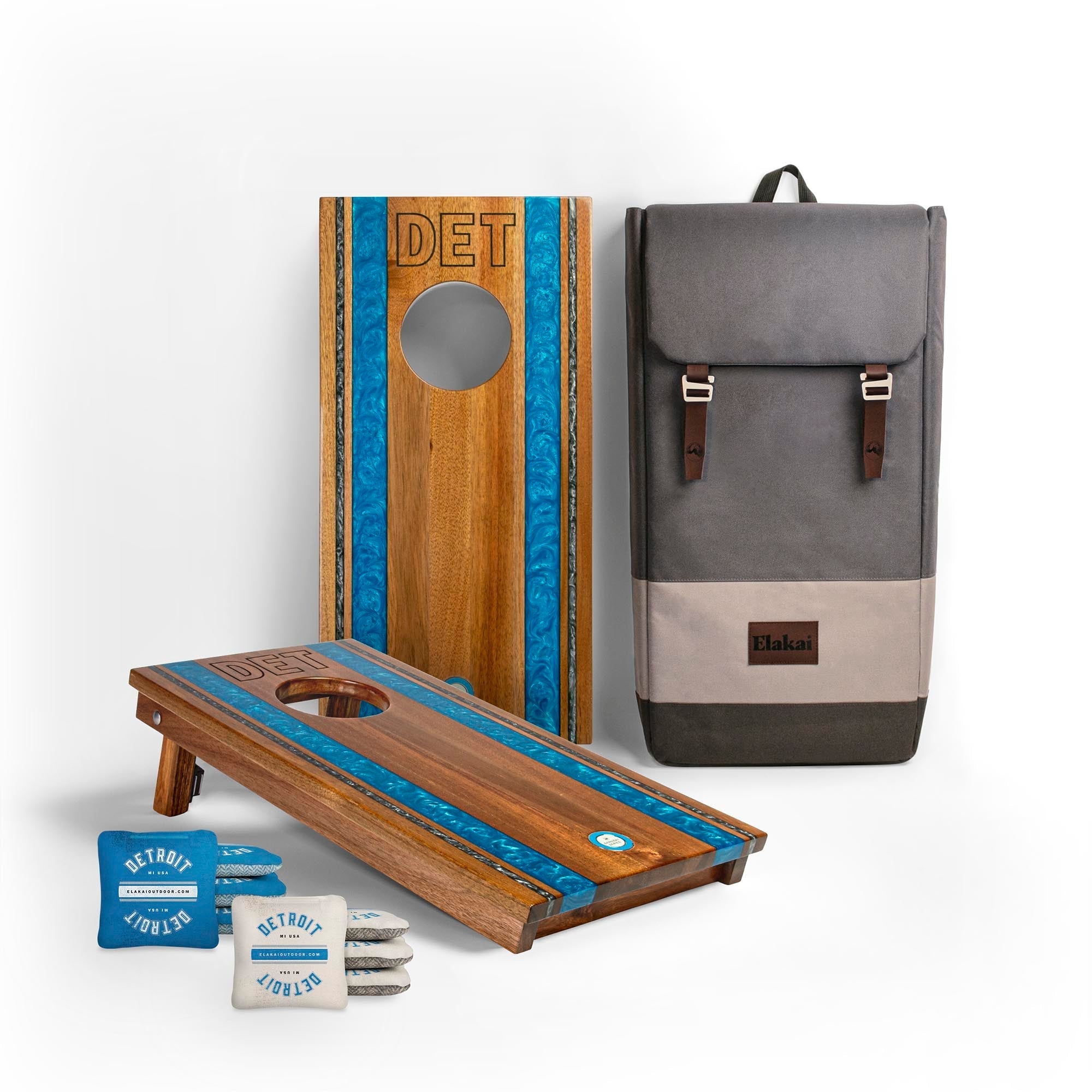 Wooden cornhole boards with blue accents and a gray backpack on a white background
#color_detroit