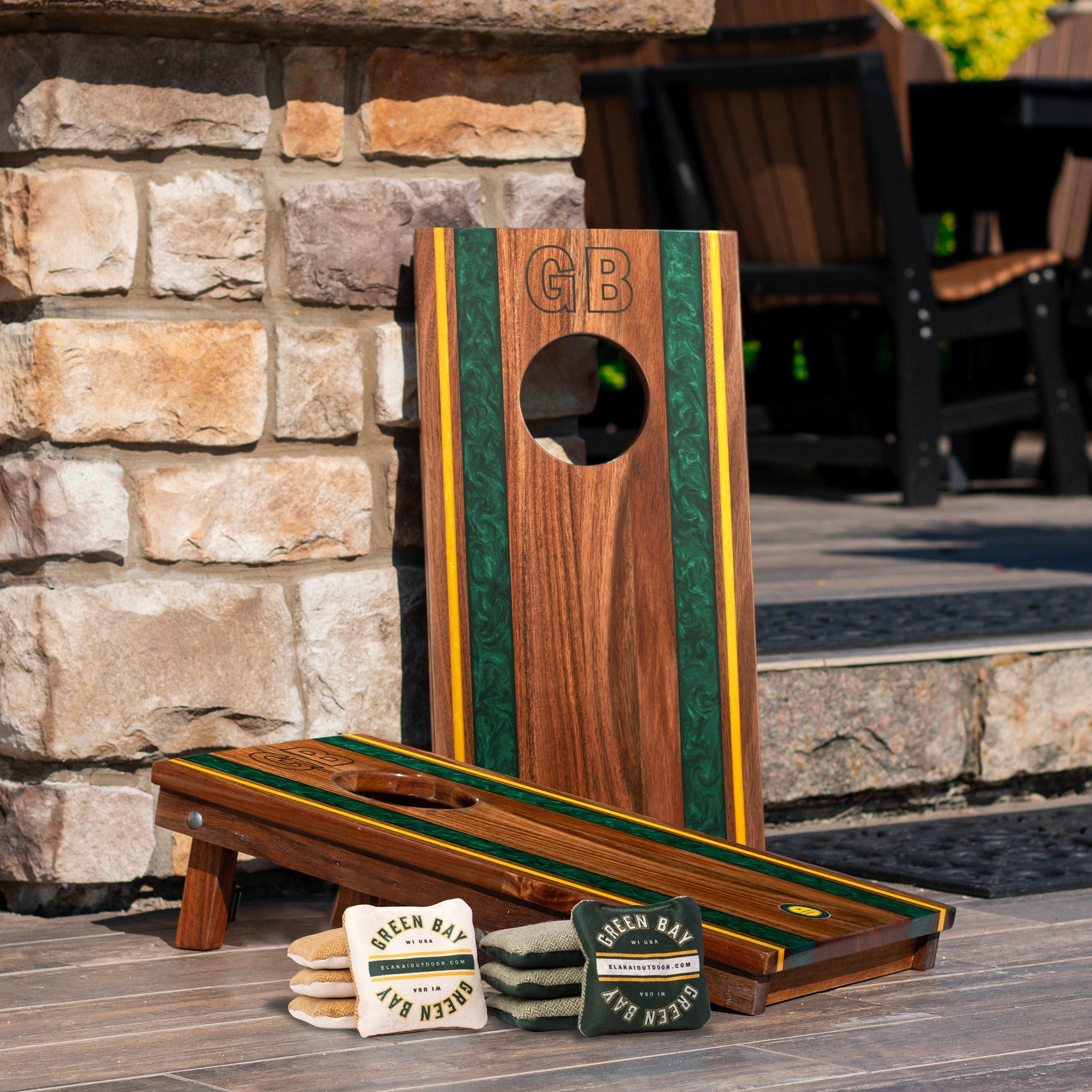 Cornhole board with 'GB' branding on a stone patio
#color_green bay