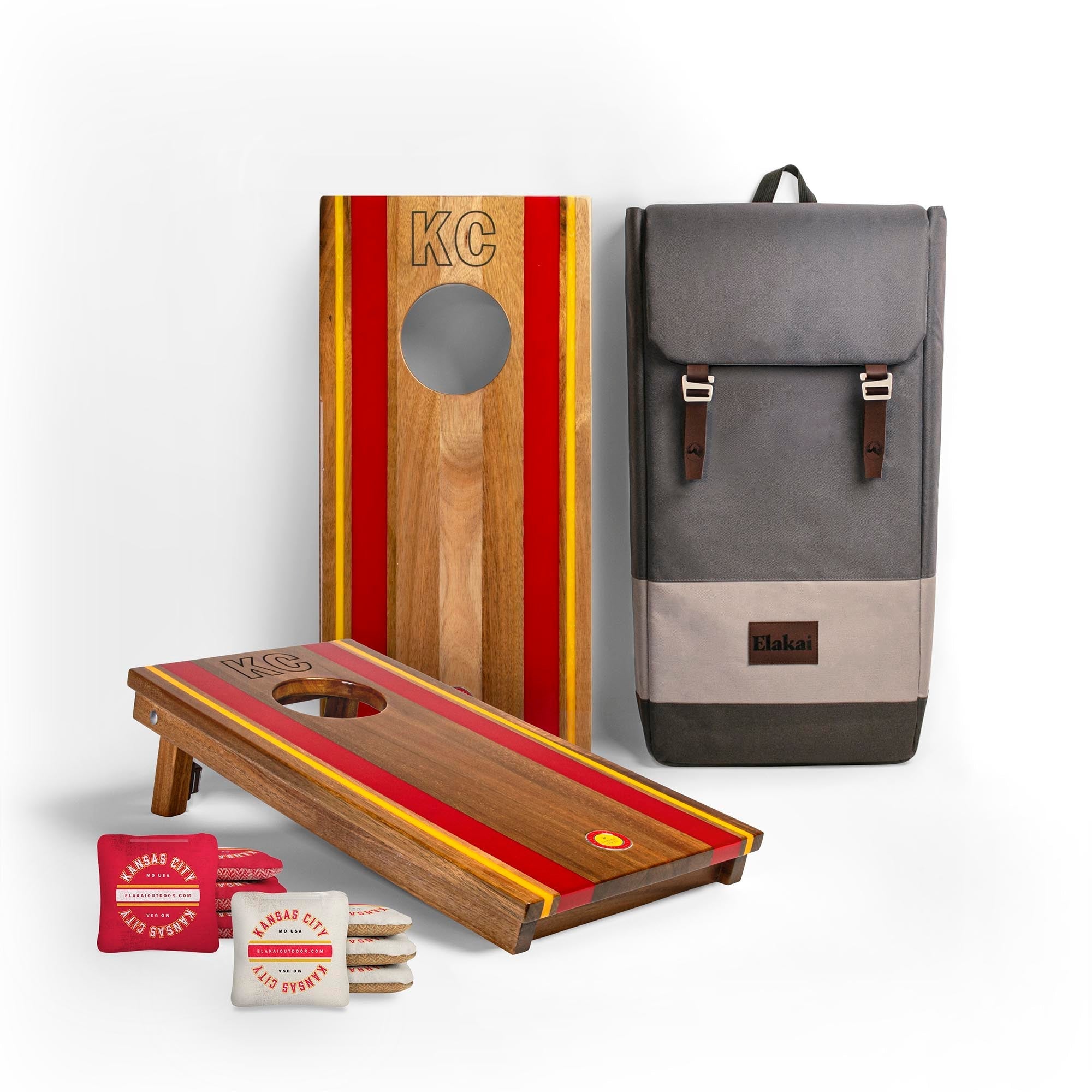 Cornhole boards with red and yellow stripes, a backpack, and branded bags on a white background

#color_kansas city
