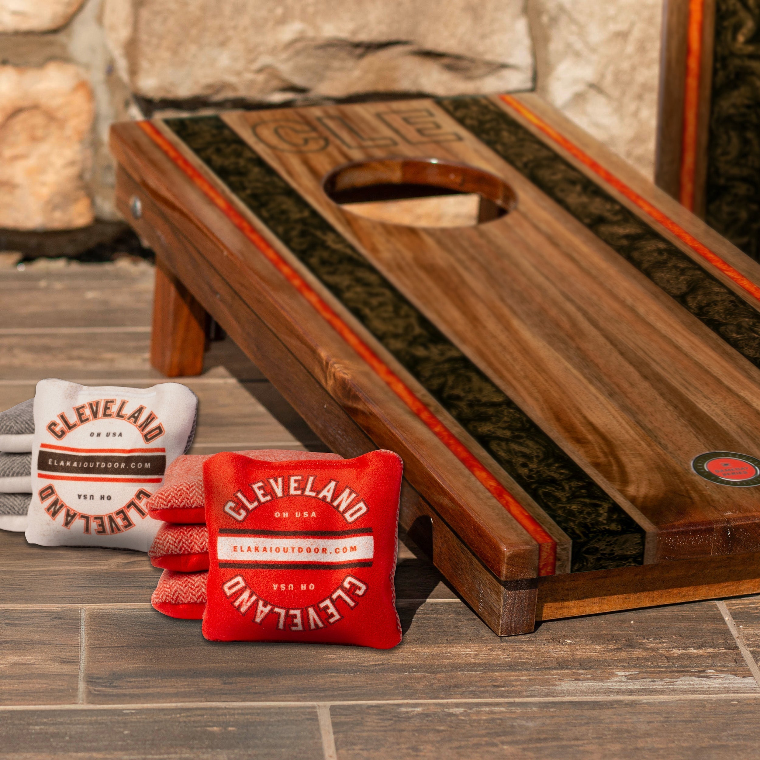Cornhole board with bags featuring 'Cleveland' branding on a wooden surface.

#color_cleveland