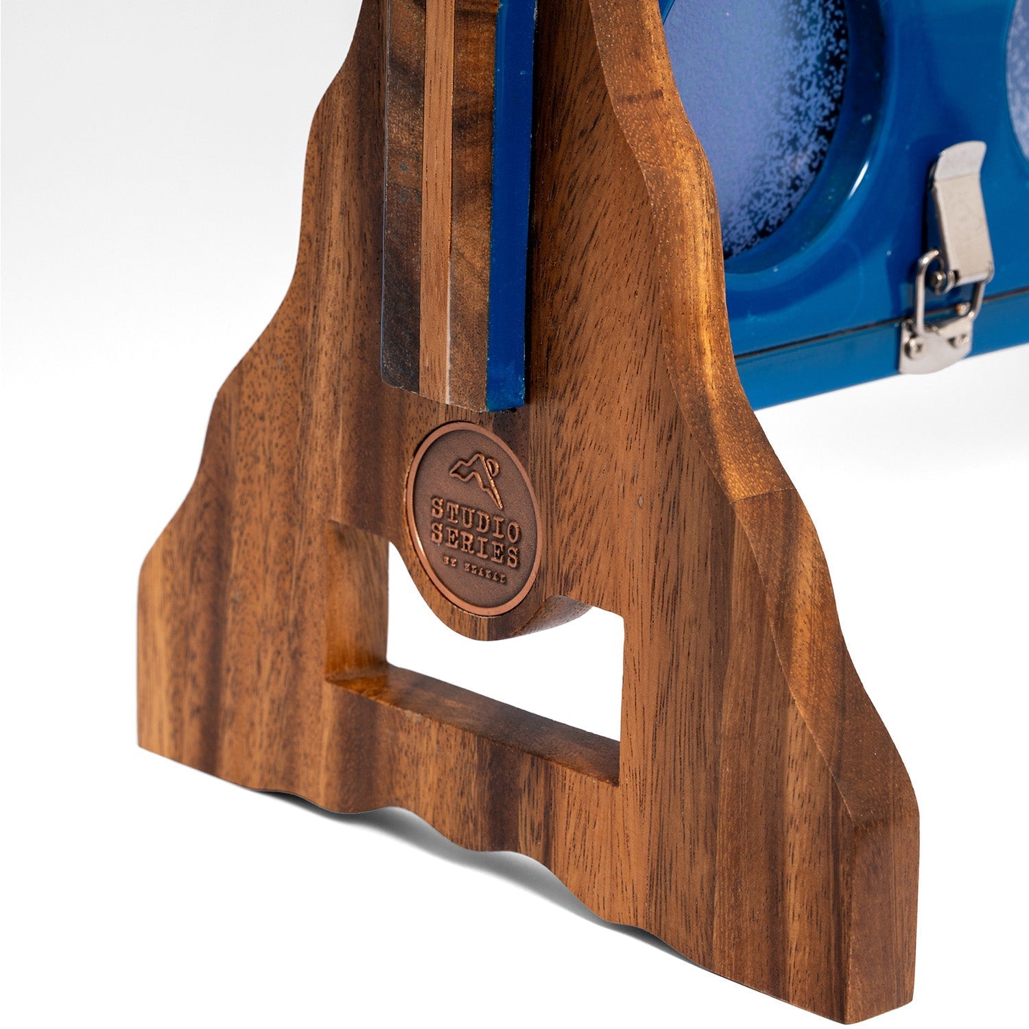 Detail of the acacia wood support leg and copper medallion on the Studio Series giant 4 in a row game